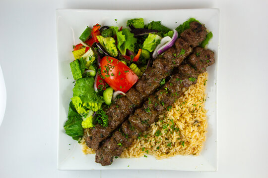 Kofta, a meatball dish found in Middle Eastern, South Caucasian, South Asian, Balkan, and Central Asian cuisines. Served with fries and salad. 