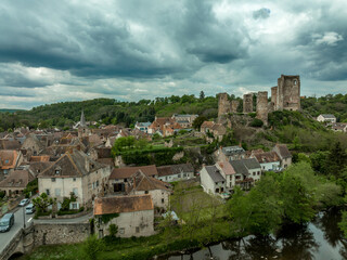 Fototapeta na wymiar Aerial view of the ruins of Herisson fortress of the Dukes of Bourbon dominate the medieval city of Hérisson and Aumance Valley with towers standing tall in the inner castle in central France