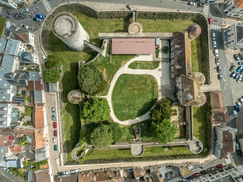 Aerial top down ground plan view of medieval Dourdan castle, square shape with eight towers including a stand alone circular donjon with drawbridge over the moat in Essone ile de France