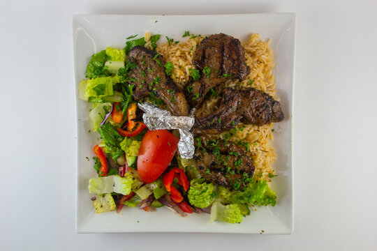 Lamb chops with rice and salad. Middle Eastern dish. 