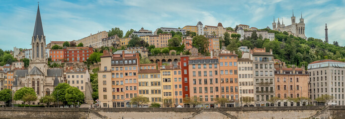 Colorful houses of Vieux Lyon on the River Saône quayside, overlooked by Renaissance-era mansions...