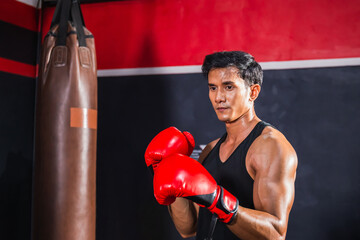 Portrait of Sportsman muay thai boxer fighting in gym, muscular handsome boxing man fighter with...