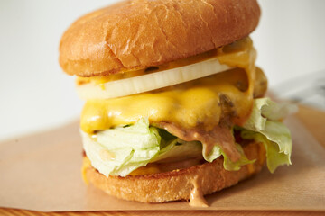 Vegetable and cheese hamburger on a cutting board