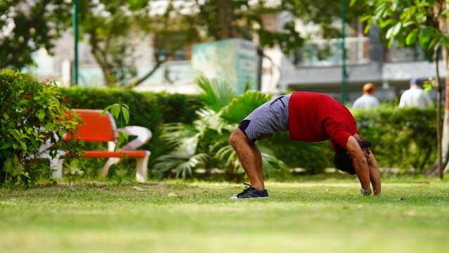 a Young Asian healthy man workout at park exercise fit doing yoga fitness concept stock images
