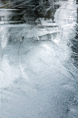 wet road in the rainy day and water puddles with raindrops