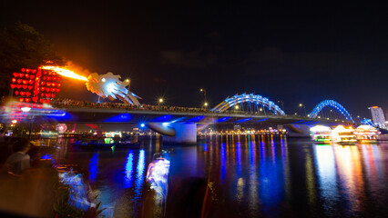 Obraz premium Dragon bridge - a famous location for tourists much attractive at night time of the weekend with fire and water spitting - Da Nang city, Vietnam.