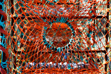 Colorful fishing lobster and crab baskets with blue and orange nets