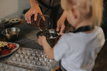 Mom and daughter make chocolate at home