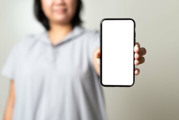 Asian young woman showing empty screen mobile phone in white color free for in put text.
