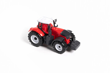 Red toy tractor isolated on white background.