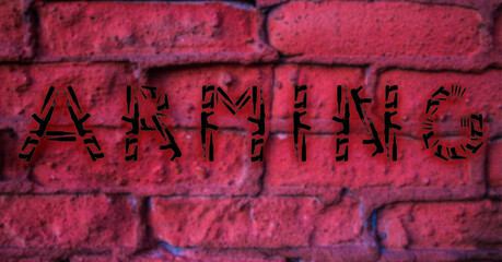 The word Arming made of pistols and machine guns on the background of a red wall
