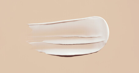 cosmetic smear cream texture on pastel beige background