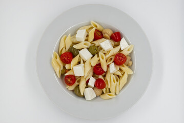 Italian Summer Salad Pasta Fredda. Fresh and healthy summer salad on white background. Top view