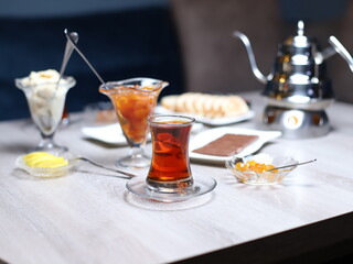 Black tea in armudu glass with teapots.