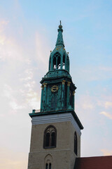 View of St. Mary's Church "marienkirche" bell tower in Berlin with clouds in sunset blue sky background.