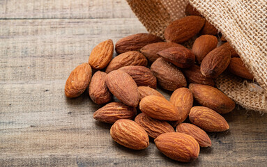 almond seeds on wooden table background, healthy food
