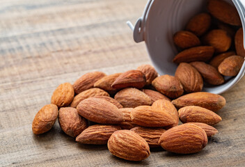 almond seeds on wooden table background, healthy food
