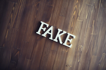 The letters spelled the word fake. The concept of modern information technology. Fake and facts in...