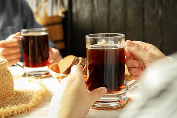 People sitting on the table and drinking kvass - obrazy, fototapety, plakaty