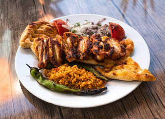 chicken wings skewers on serving white plate, 