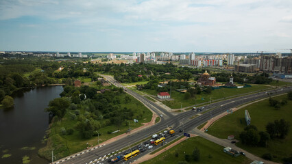 Fototapeta premium Crossroads of a large city highway. The flow of cars starts moving at a traffic light. Aerial photography.