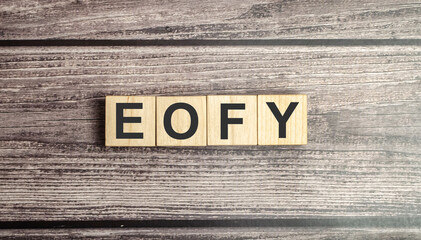 wooden cubes with the word End of Financial Year on wooden background