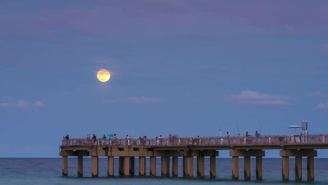 Full moon rise over pier in Miami
