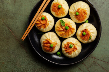 Xiao Long Bao or Baozi or Sheng Jian Bao, is a type of yeast-leavened meat filled buns, steamed and pan fried. Chinese dish. Directly above.