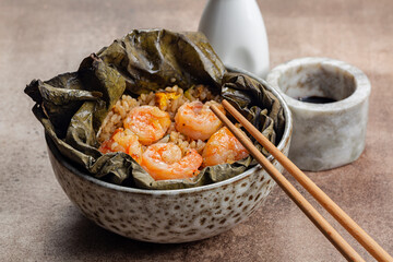 Lotus Leaf Wrap with shrimps, rice, vegetables and egg. He Ye or Lo Mai Gai,. Soy sauce. Traditional chinese food.