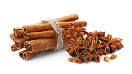 Aromatic cinnamon sticks and anise stars with seeds on white background