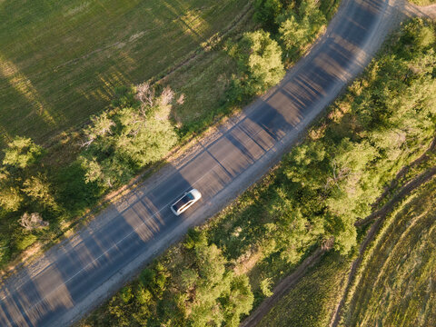 Car on road in the summer time nature from air . View from a drone. Aerial view.