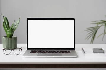 Laptop mockup, computer with empty blank white screen in modern office interior. Home office, workplace, working or studying from home, distance learning, business and technology concept