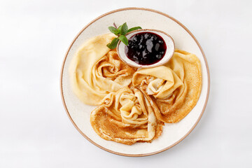 Pancakes with jam on a white background