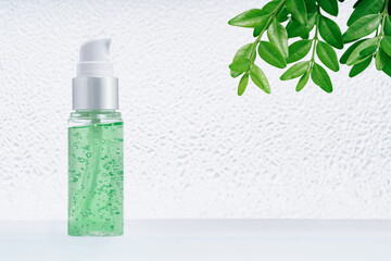 Natural medicine or beauty essence concept green mockup doser vial with air bubbles on glass stand...