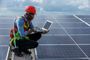 Engineer working setup Solar panel at the roof top. Engineer or worker work on solar panels or solar cells on the roof of business building	