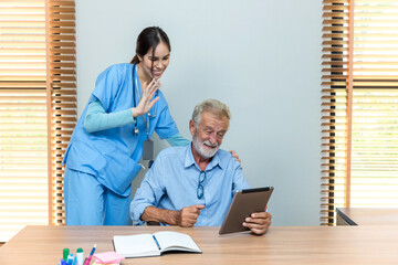 Senior man and woman making online call using tablet. Nurse Helps Senior man Video Chat On Tablet In Nursing Home Or At Home