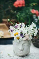meadow flowers in the Buddha vase