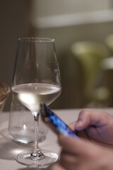 person who is looking to the mobile at the restaurant