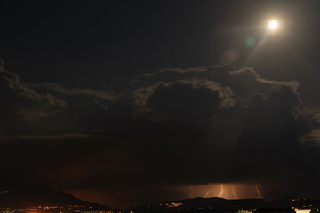 Night thunderstorm in the light of the moon. Amazing view - 512014546