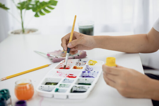 Close-up  Paint on a drawing board in the house to create art with watercolors and brushes.