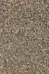 Dried Valerian root pieces (Valeriana officinalis), closeup background image. Traditional medicinal herb also used as a cat attractant.