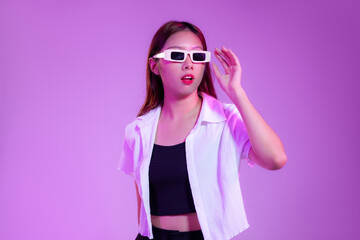 Young asian woman wearing white retro sunglasses posing on the purple screen background.