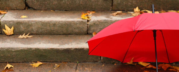 Bright umbrella on stairs outdoors. Banner for design