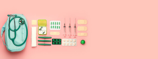 First aid kit on pink background with space for text