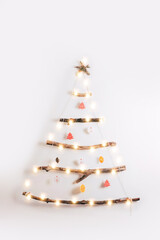 Minimalistic style Christmas tree on white background.
