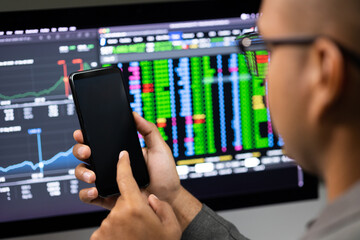 Close-up financial using smartphone analyze exchange rate diagram. Investor businessman analyzing a graphic of stock cryptocurrency exchange chart with cell phone. Investment concept