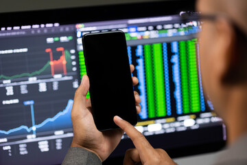 Close-up financial using smartphone analyze exchange rate diagram. Investor businessman analyzing a graphic of stock cryptocurrency exchange chart with cell phone. Investment concept