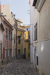Winding alleyways with old buildings and balconies in Lisbon, Portugal
