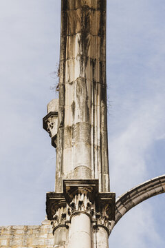 A stone pillar rises up towards the sky from the ruins of a church in Lisbon