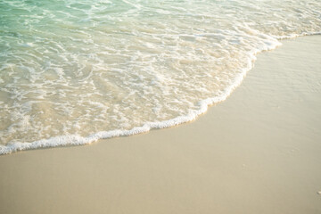 Soft wave on sand beach at coast with blue sea ocean tropical nature. tourism vacation travel summer in holidays. white texture wallpaper island flat lay.